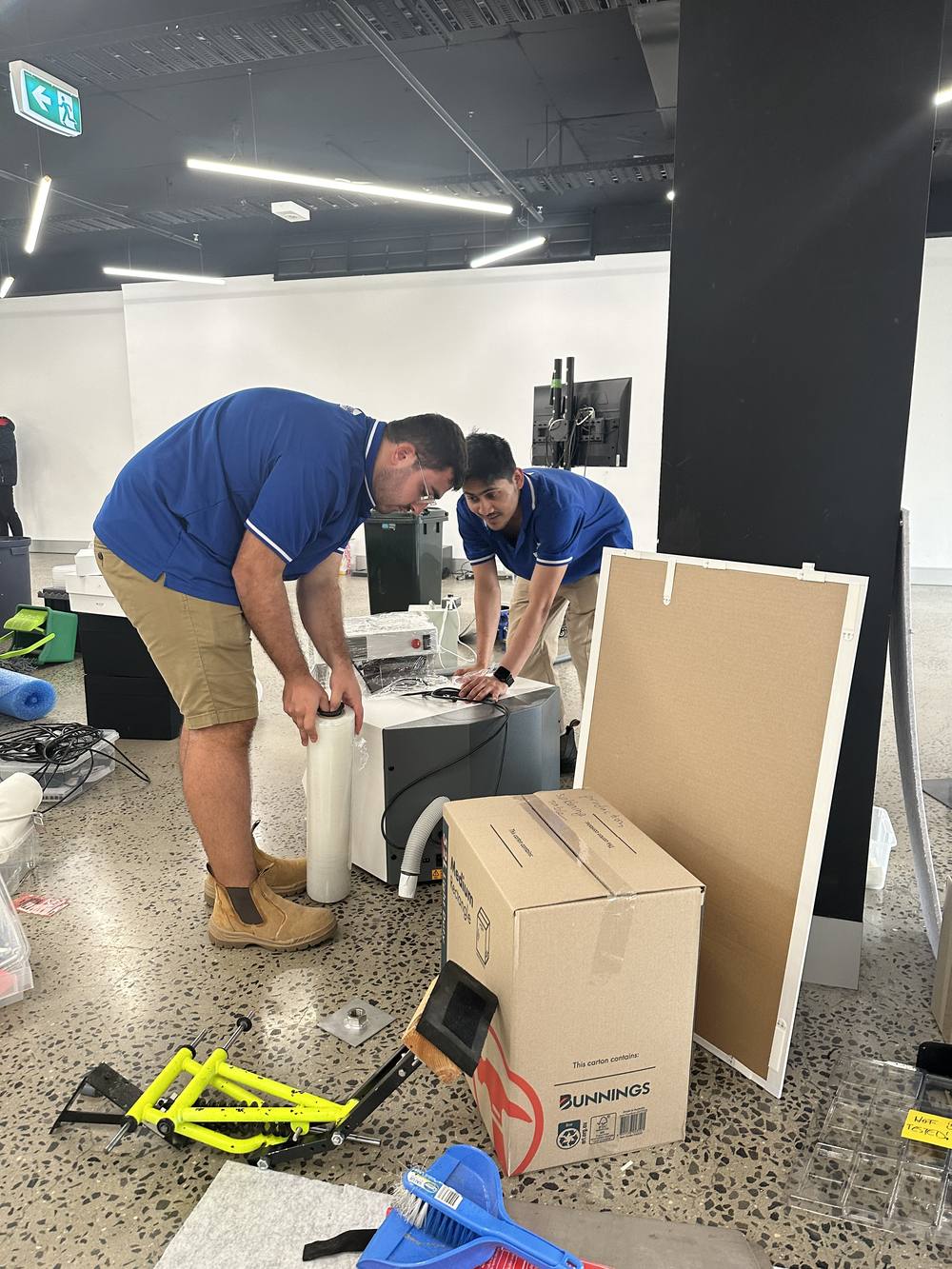 Move On Removals crew wrapping office equipment for transit