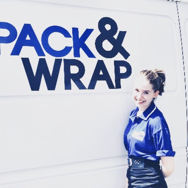 Pack and Wrap team member beside branded van