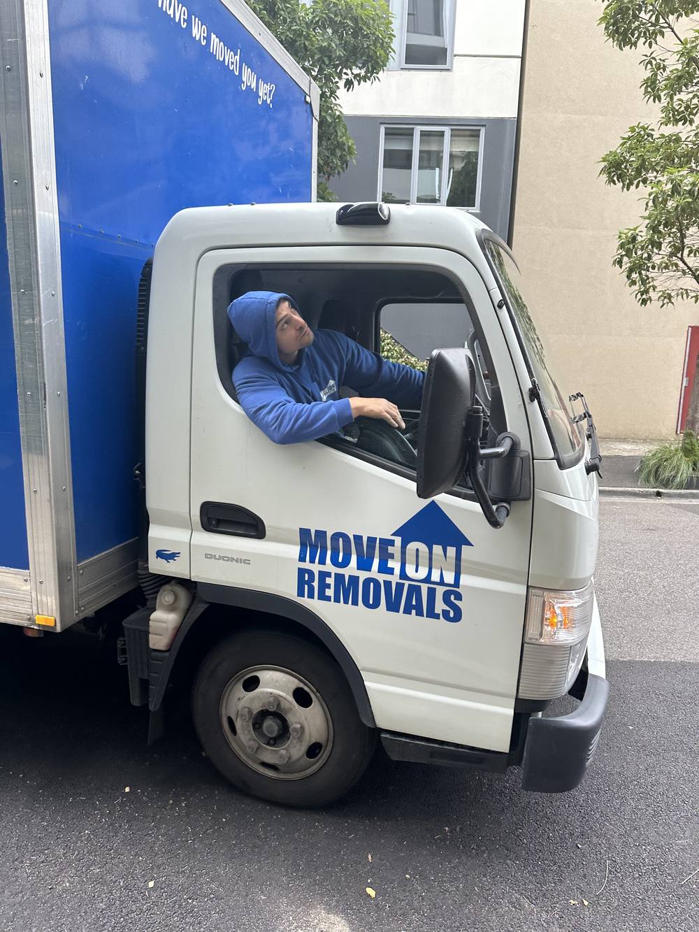 Move On Removals branded truck, crew member at the wheel