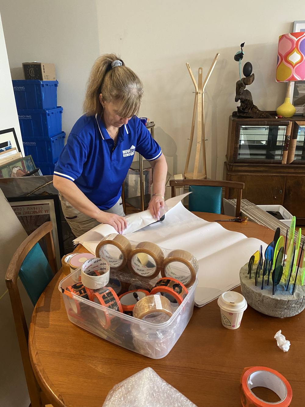 Packing tape, crates and wrapping paper laid out for a pack