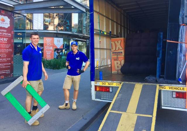 Two Move On Removals crew members by the open truck ramp