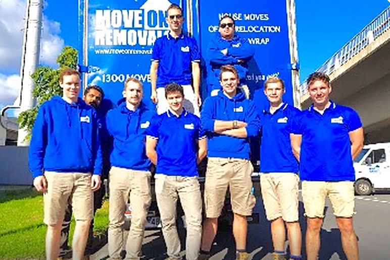 The Move On Removals team in branded uniforms in front of a company truck